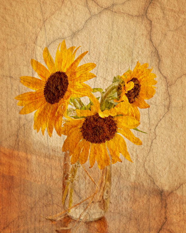 Sunflowers in a vase on a table with a texture applied to the image